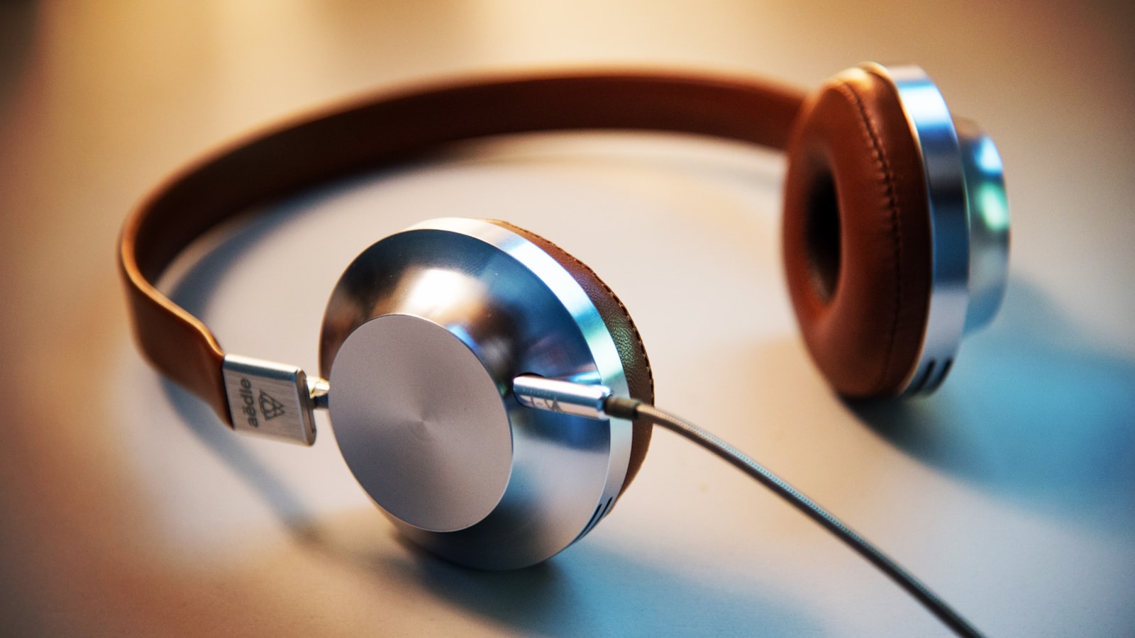 Over-ear headphones resting on a wooden desk