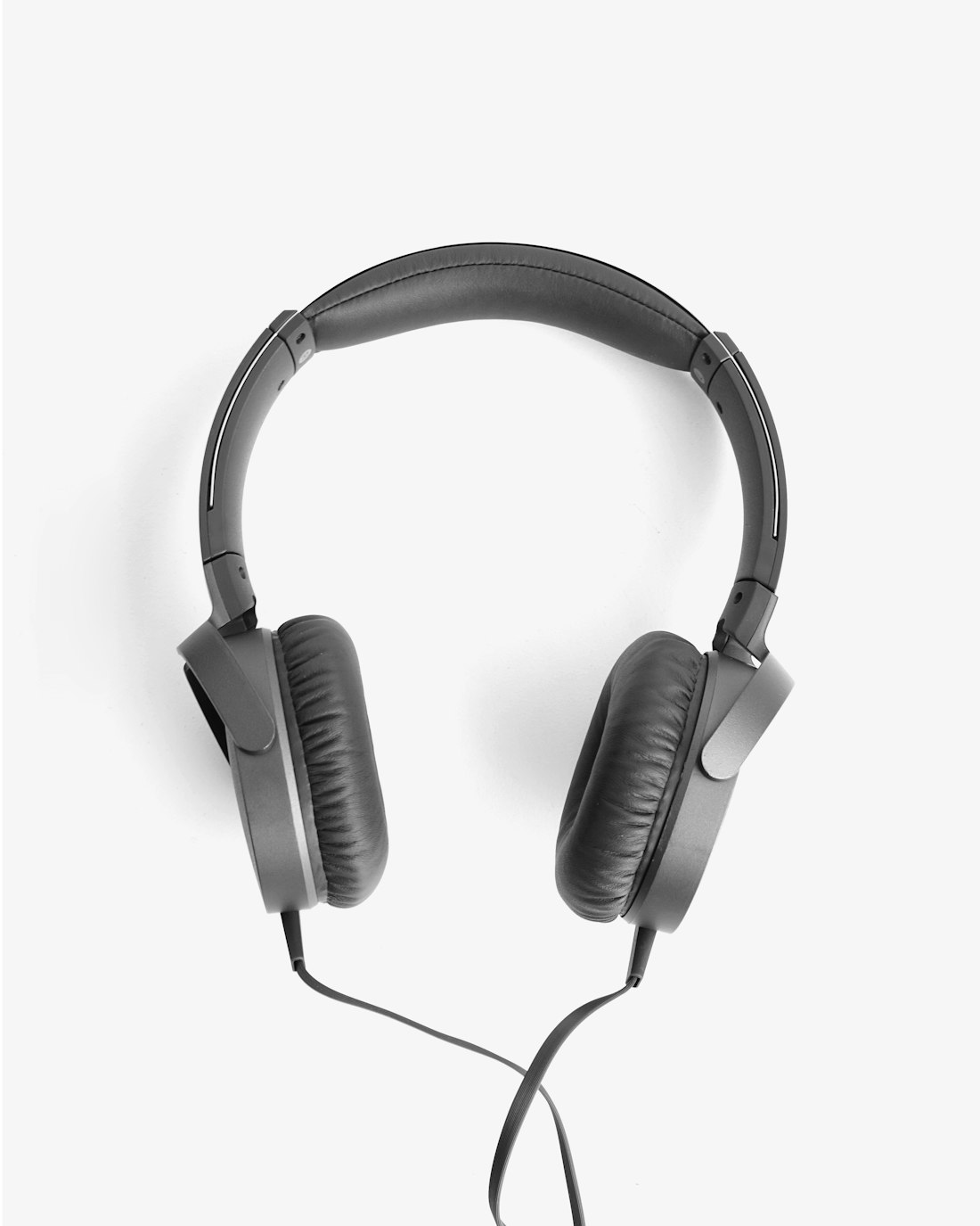 A pair of premium over-ear headphones resting on a stand